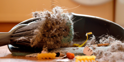 Broom sweeping up dust and debris